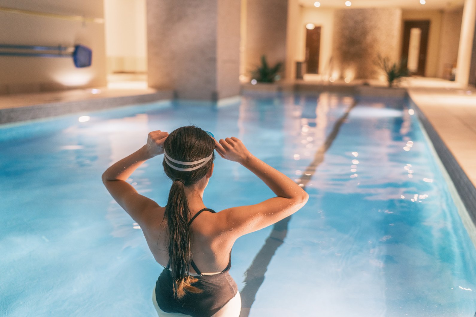 Woman Getting Ready to Swim in Indoor Pool